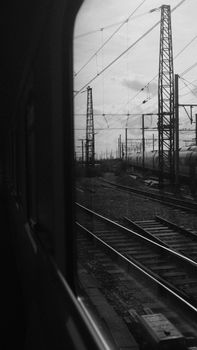 Black and white view from a train window showing railway tracks in Brussels, Belgium.
