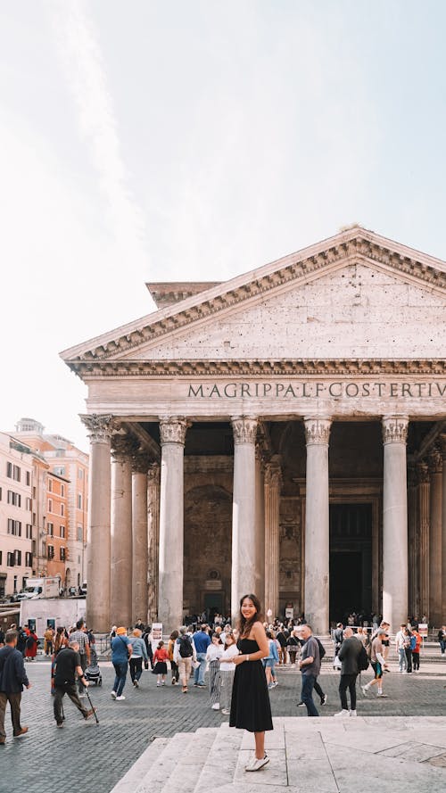 A woman standing in front of the pantheon