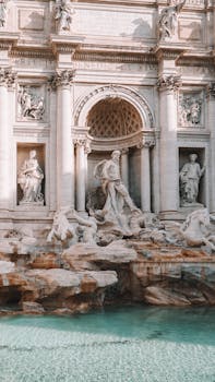 Elegant view of the Trevi Fountain showcasing its Baroque architecture and sculptures in Rome, Italy.
