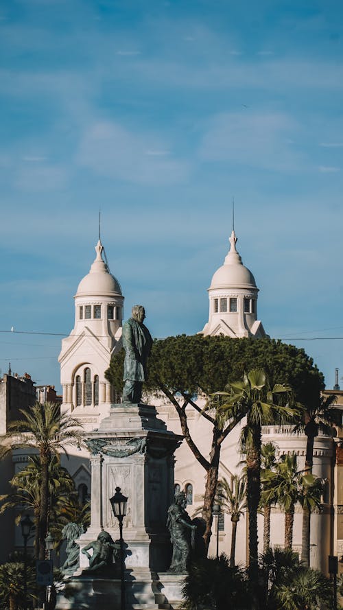 A statue and a church in the background