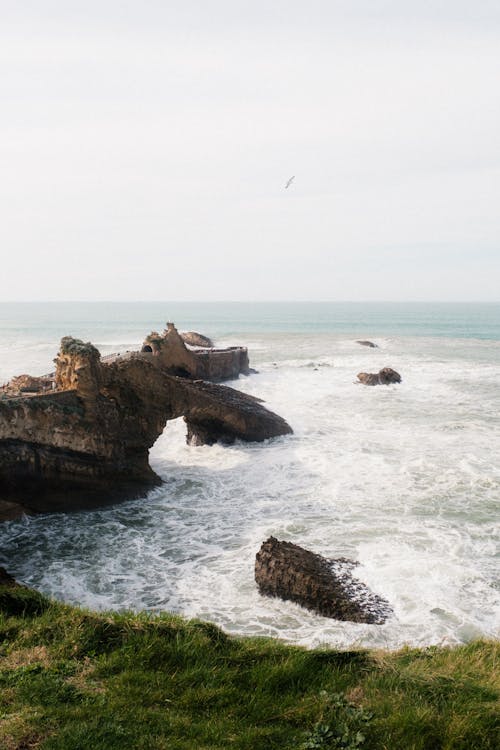 A photo of a rocky shore with waves crashing