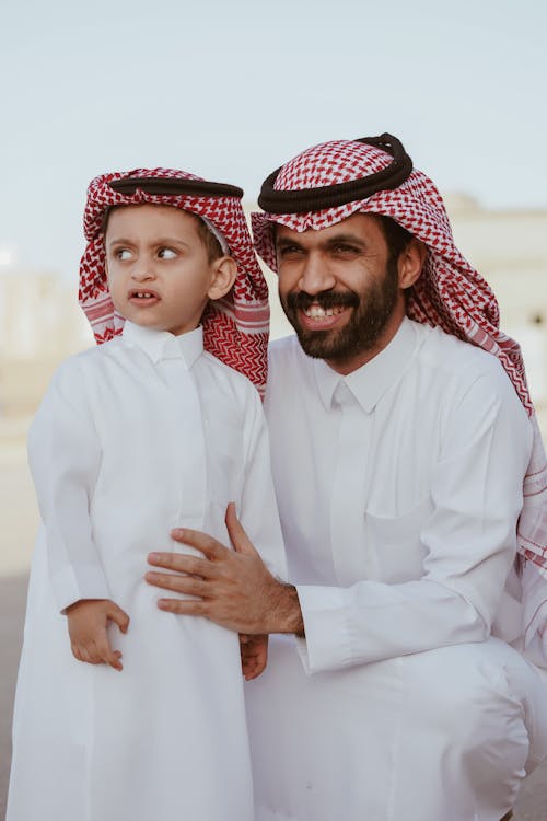Free Smiling Father with Son in Traditional Clothing Stock Photo