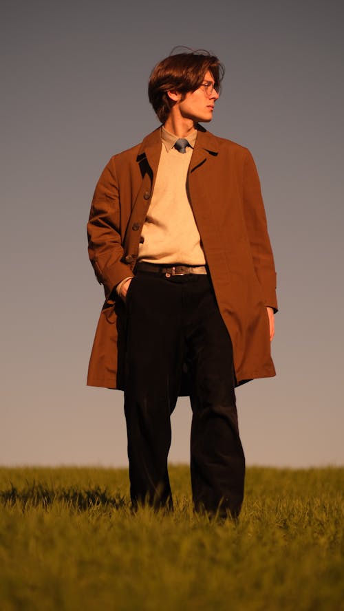 Free A man in a brown coat standing in a field Stock Photo