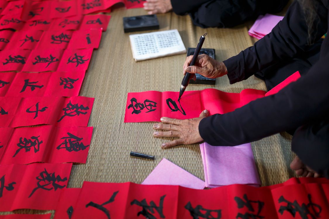 Person Writing On Red Paper · Free Stock Photo