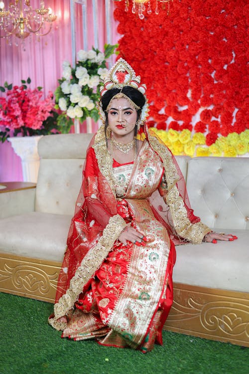 A woman in traditional attire sitting on a couch