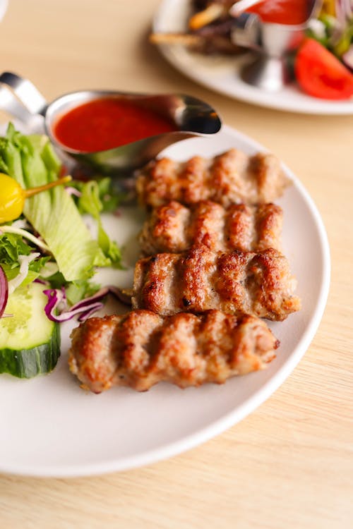 Free A plate of meat and vegetables with a salad Stock Photo