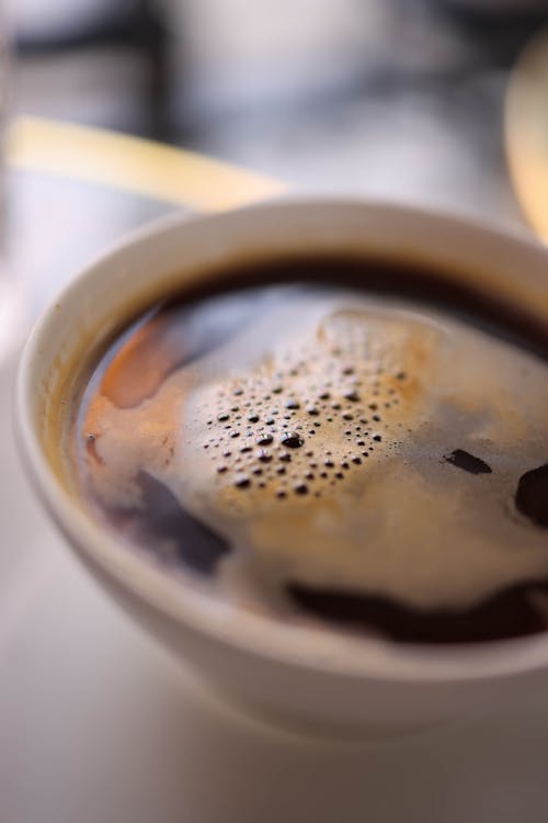 Free A close up of a cup of coffee on a saucer Stock Photo