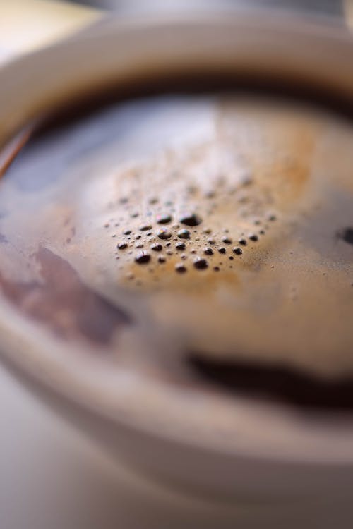 Free A close up of a cup of coffee with a small amount of liquid Stock Photo