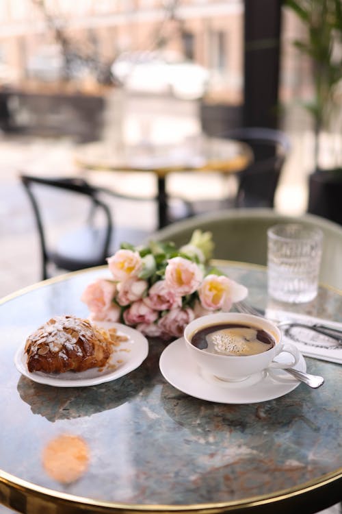 Coffee and Croissant on Cafe Table