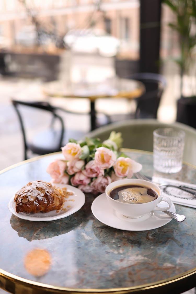 Coffee And Croissant On Cafe Table