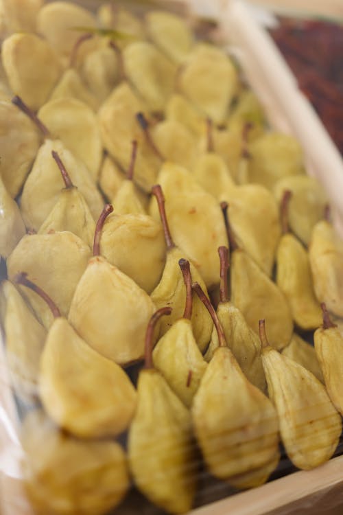 A tray of pears is displayed in a store