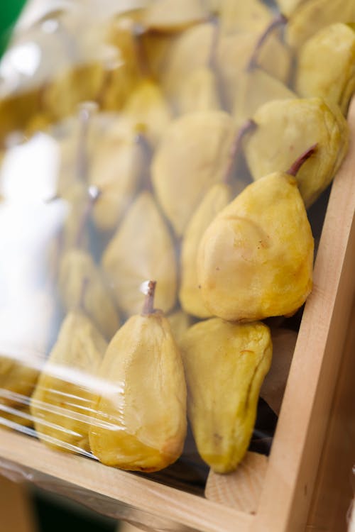 A wooden box filled with pears and other fruits