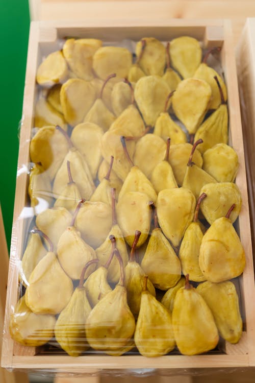 A box of pears sitting on top of a table