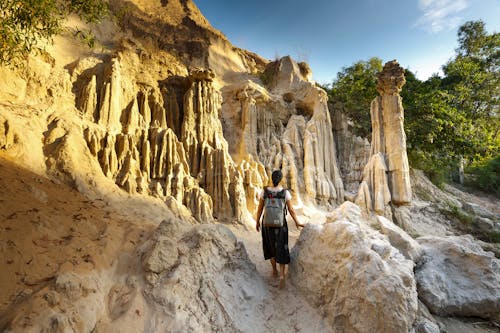 Free Woman Standing Near Rock Formation Stock Photo
