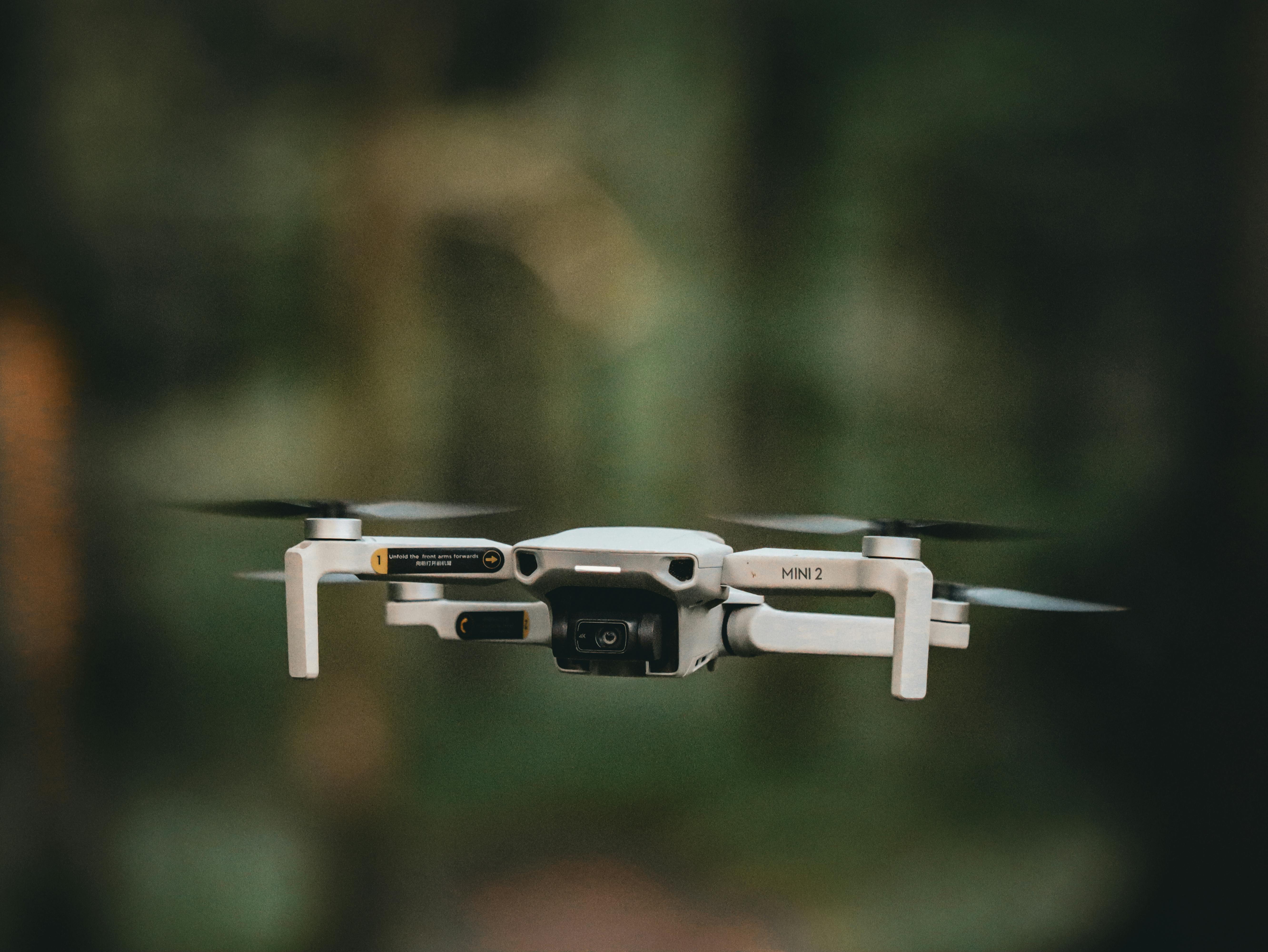 Detailed image of a drone in flight with blurred outdoor background. Perfect for technology and aerial themes.
