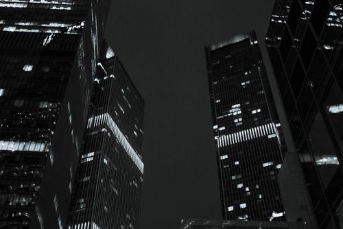 Free Low angle view of illuminated skyscrapers in Moscow at night, showcasing modern architecture. Stock Photo