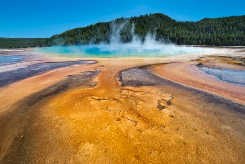 Free Bright and colorful geothermal spring at Yellowstone National Park, WY, showcasing vivid colors and steam. Stock Photo