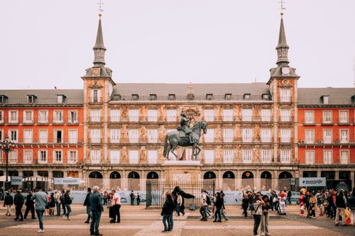 Free Crowds gather at the historic Plaza Mayor in Madrid, España with its iconic architecture. Stock Photo