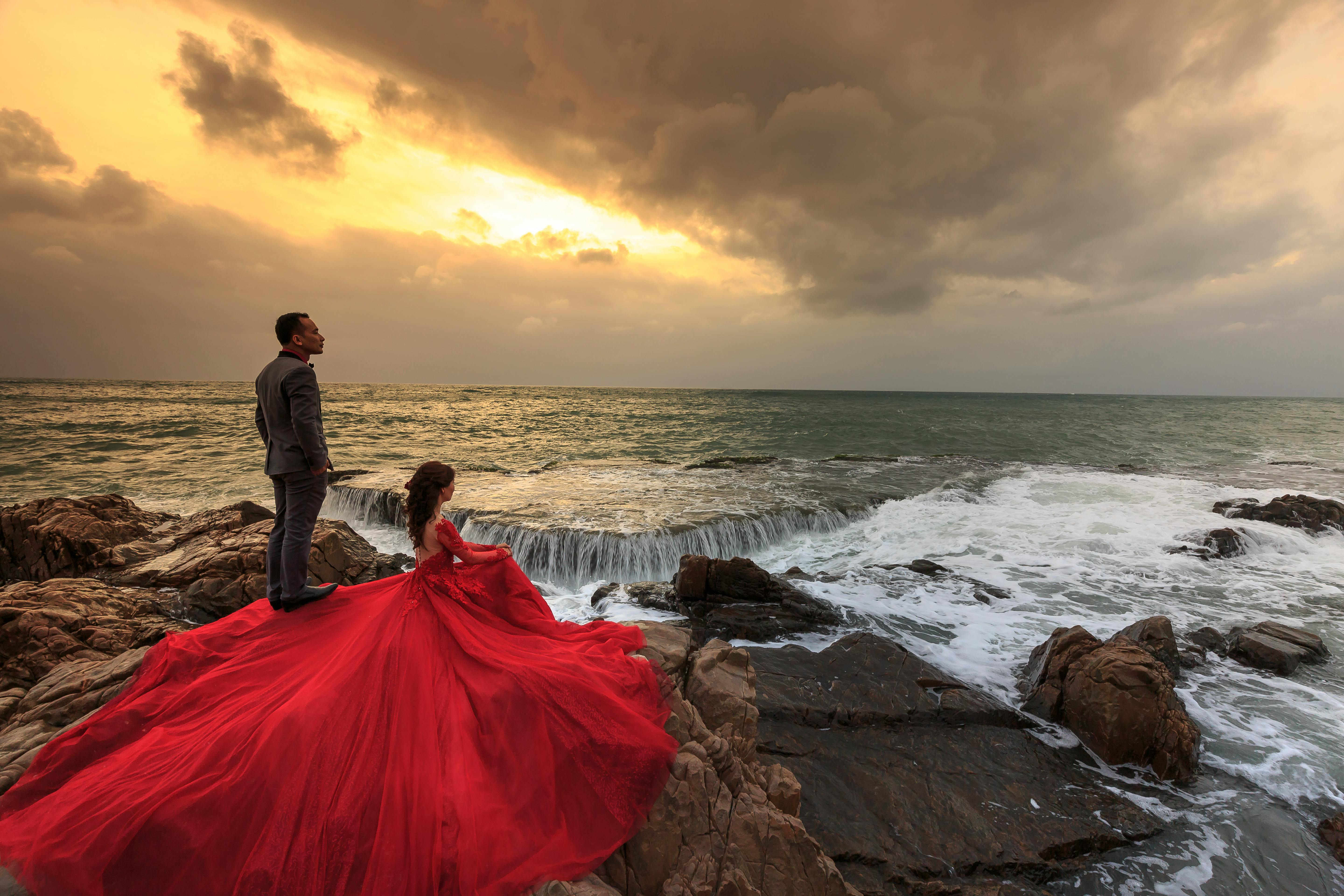 Photo of Couple portrait with bride in red gg gown