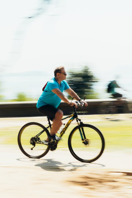 Free A man riding a bike on a road Stock Photo