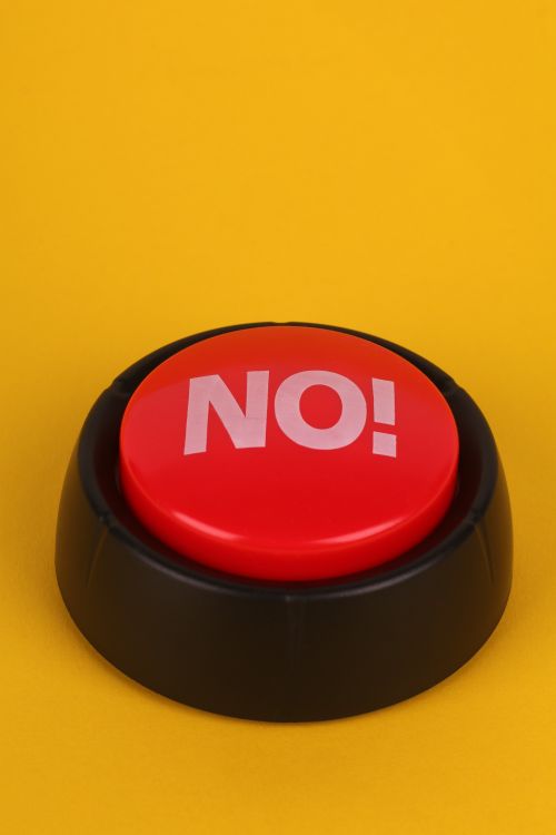 Red Button on Bright Yellow Background · Free Stock Photo
