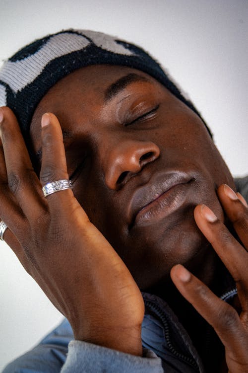 Free Portrait of a Young Man Posing with Closed Eyes Stock Photo