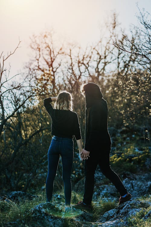 Two People Standing Near Trees