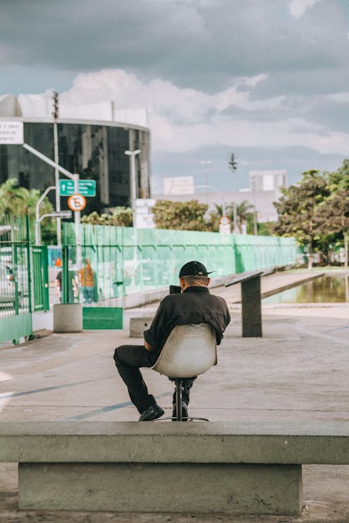 Person Sitting On White Chair At The Park