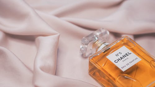Free Chanel perfume bottle on a silk sheet Stock Photo