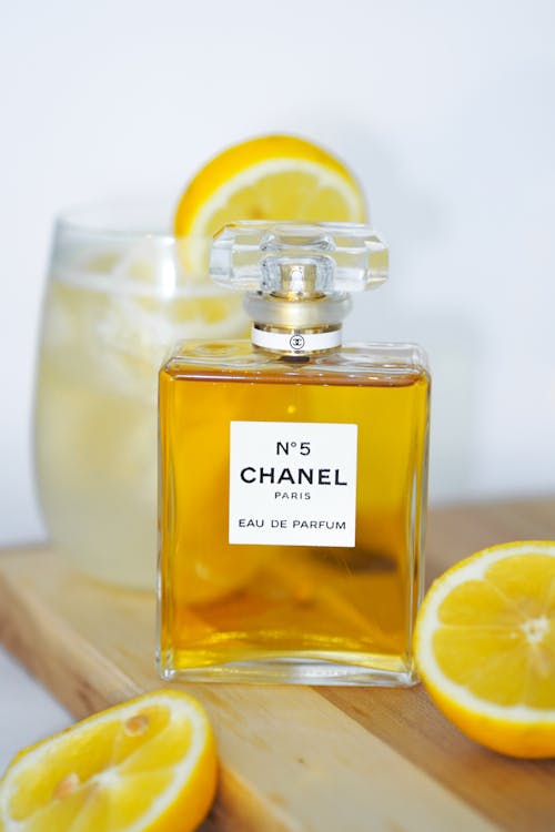 A bottle of chanel perfume with lemon slices