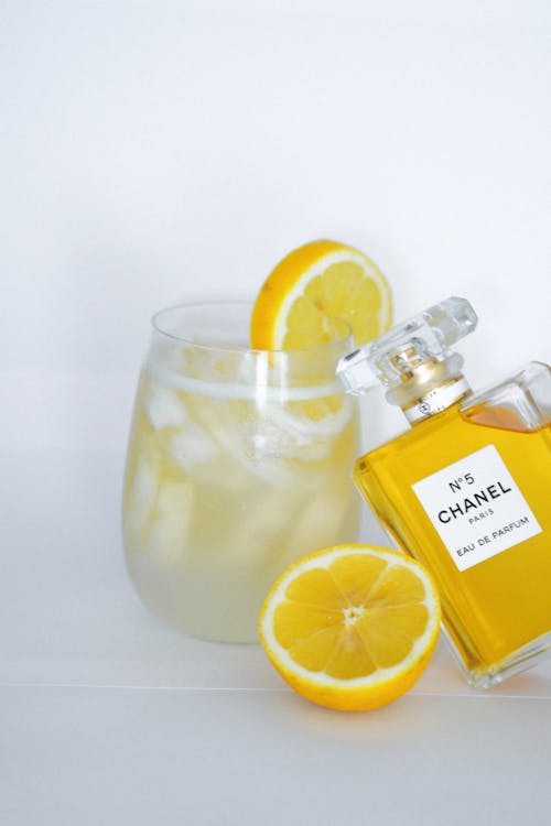 Free A bottle of perfume and a glass of lemonade Stock Photo