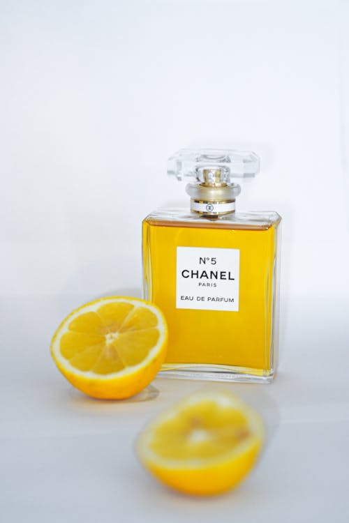 A bottle of chanel perfume with a lemon slice
