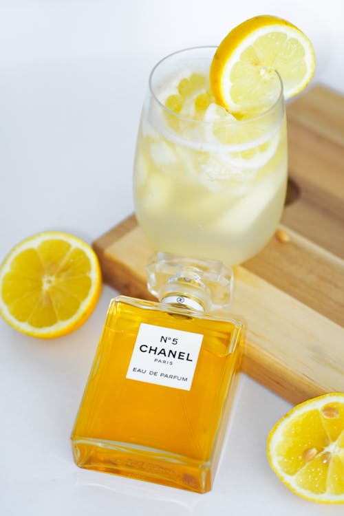 A bottle of chanel lemonade with a slice of lemon