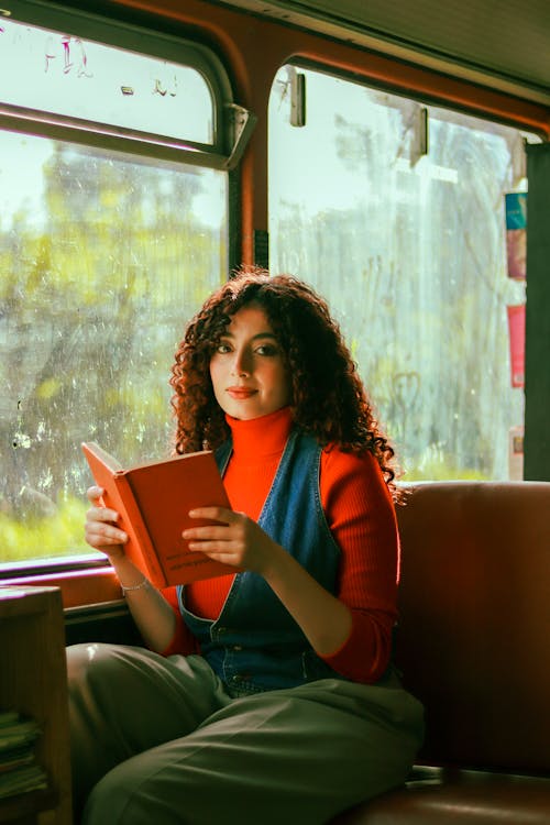 Young Brunette with Book on Bus
