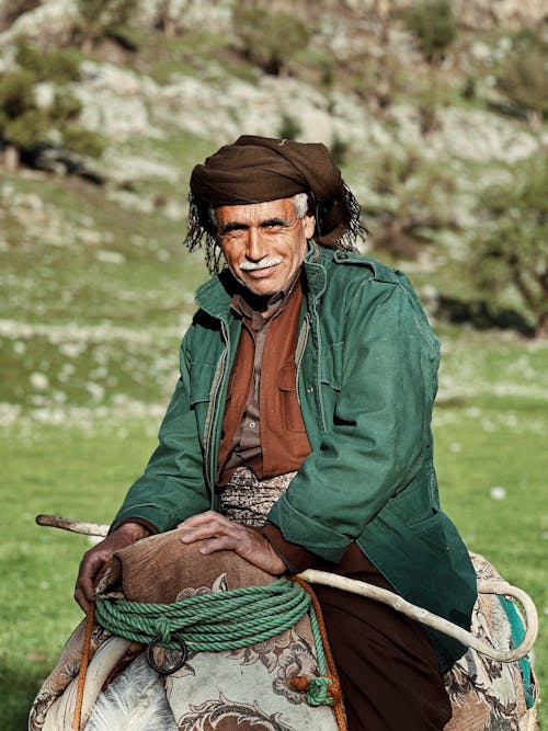 Elderly Man Sitting in Saddle