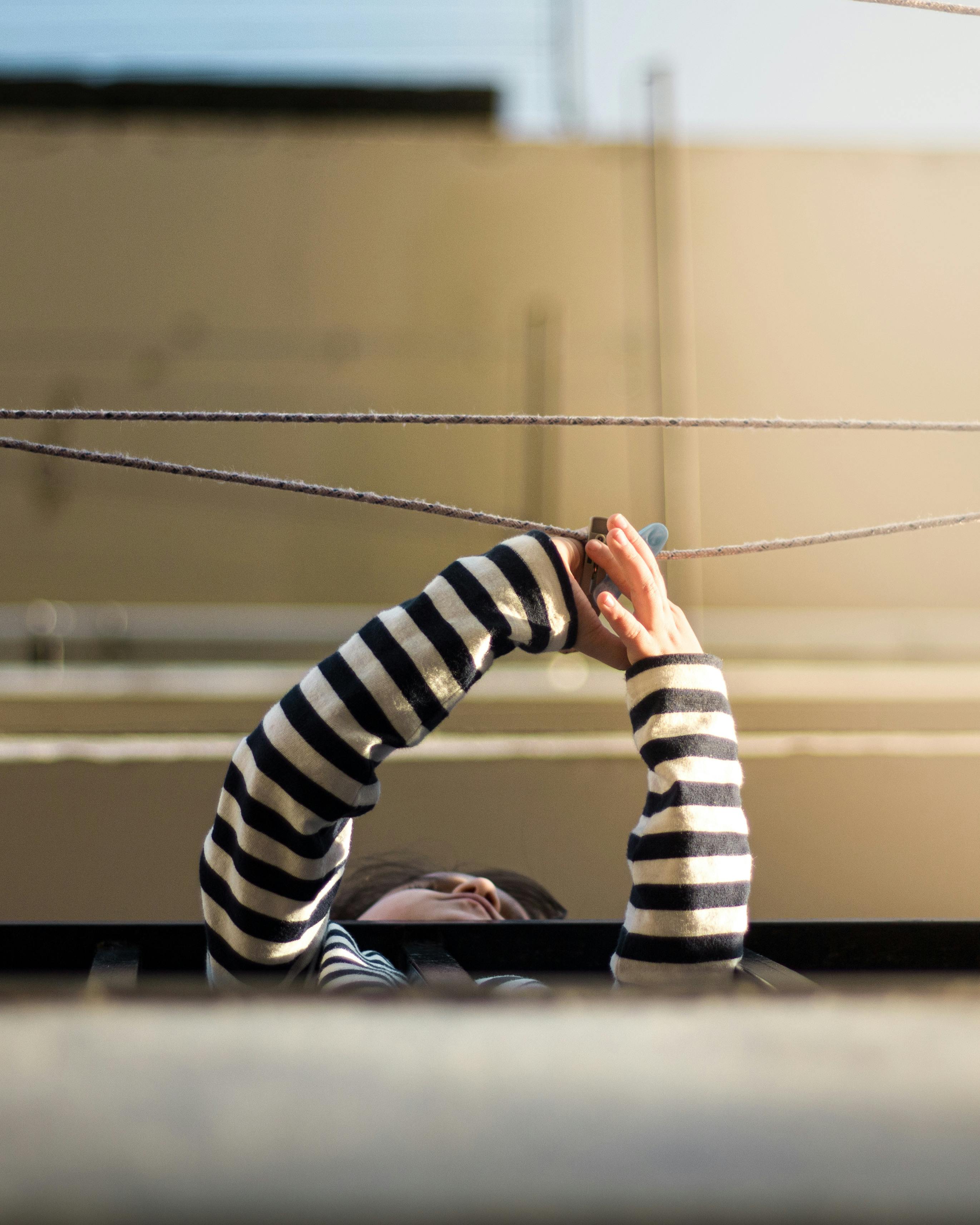 Woman with Stripped Blouse Holding a String · Free Stock Photo