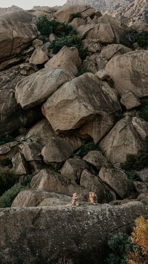 A couple is standing on top of a rock formation