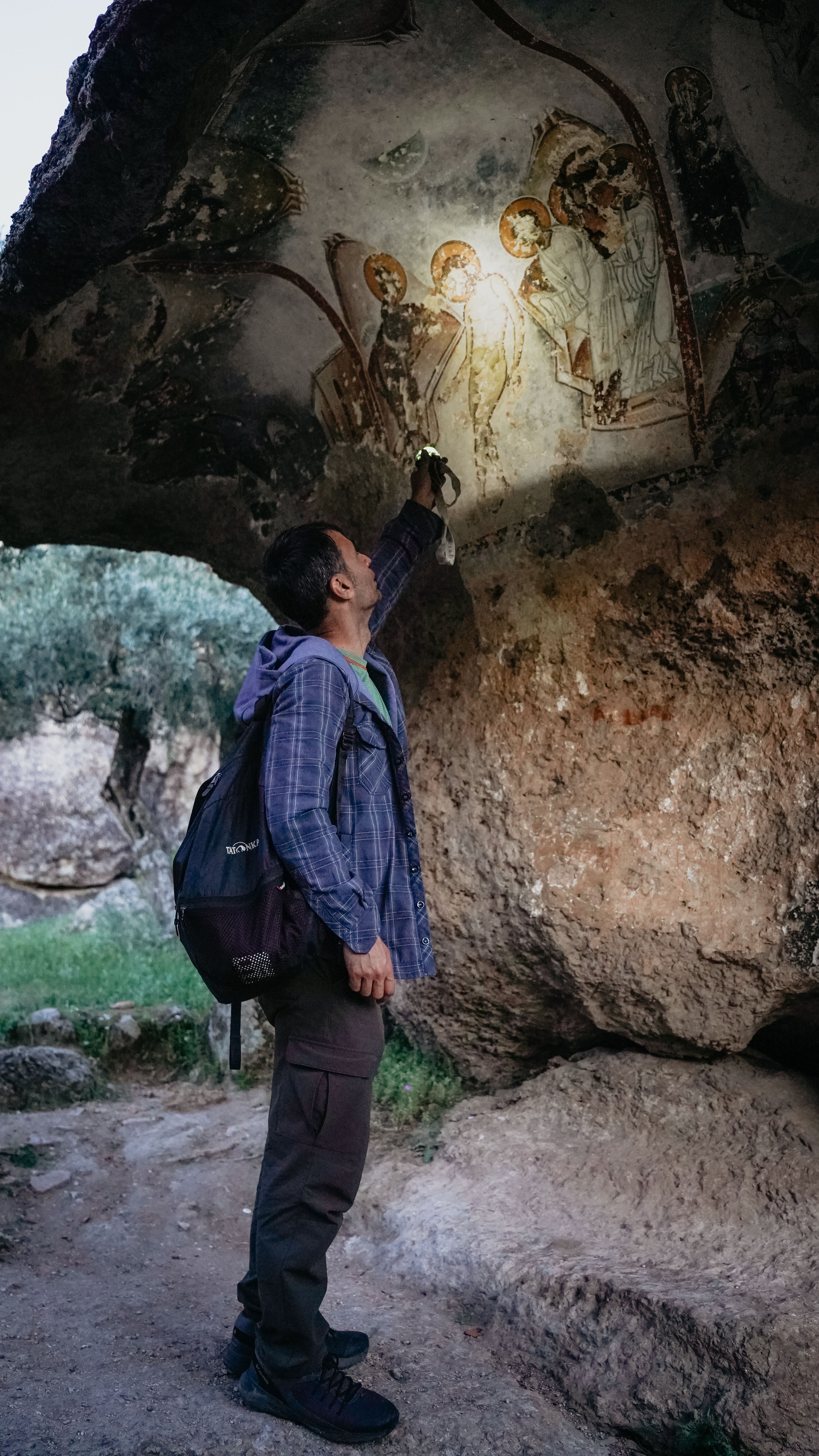 Man Looking at Ancient Paintings on Rocks · Free Stock Photo