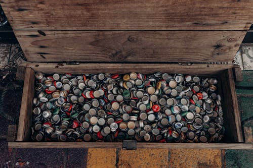 A wooden crate filled with beer caps