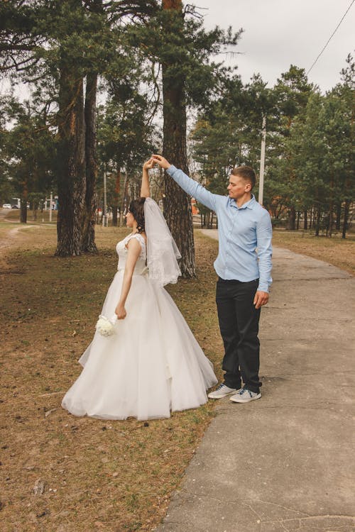 A bride and groom standing in the woods