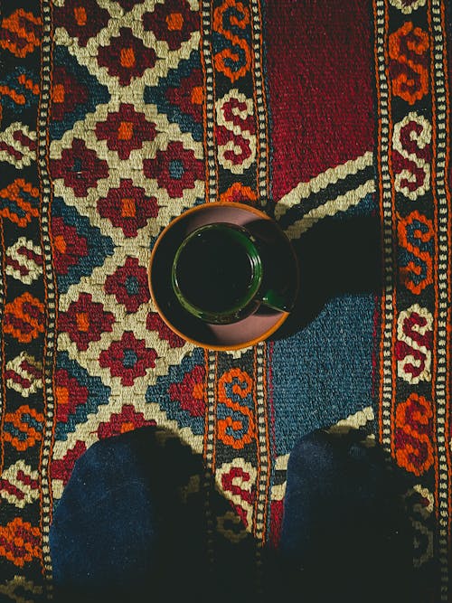 Free A coffee cup on a rug Stock Photo