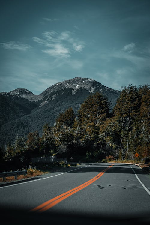 A road with mountains in the background