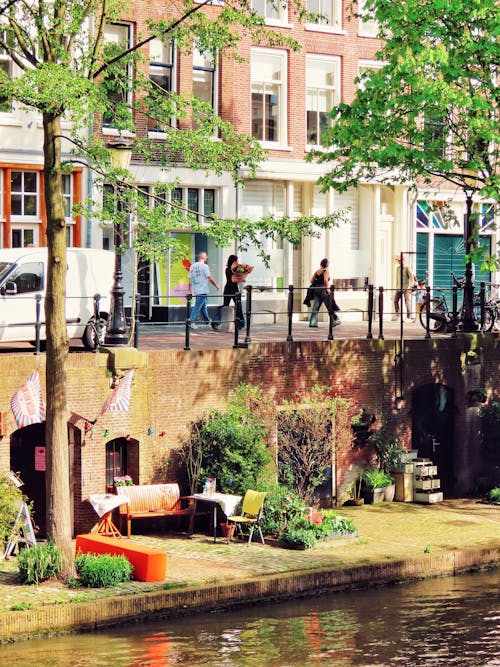 View of Waterfront Buildings and People Walking by the Canal in Utrecht, the Netherlands