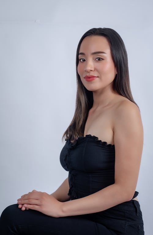 Free A woman in a black top posing for a photo Stock Photo