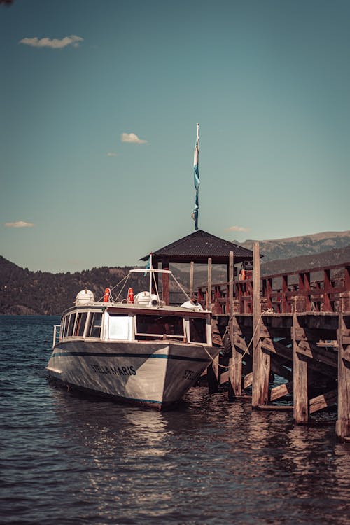 A Boat Moored to a Pier on Quila Quina Beach in San Martin de los Andes, Argentina