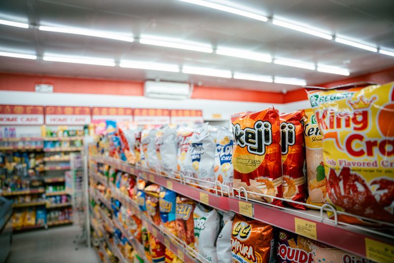 Wide shot of a vibrant snack aisle in a supermarket — photo by Kenneth Surillo on Pexels