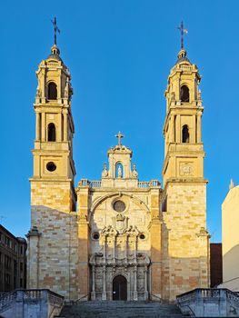 Front view of a Renaissance cathedral with twin towers in León, Spain, under clear sky.