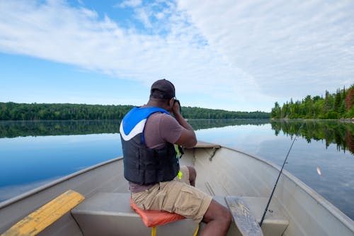 A man sitting in a boat on a lake