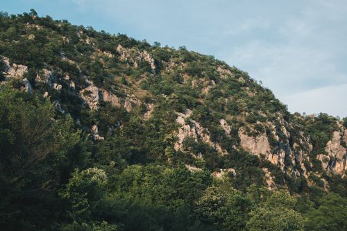 Free Vibrant landscape of rocky hills covered with lush greenery in Spuž, Montenegro. Stock Photo