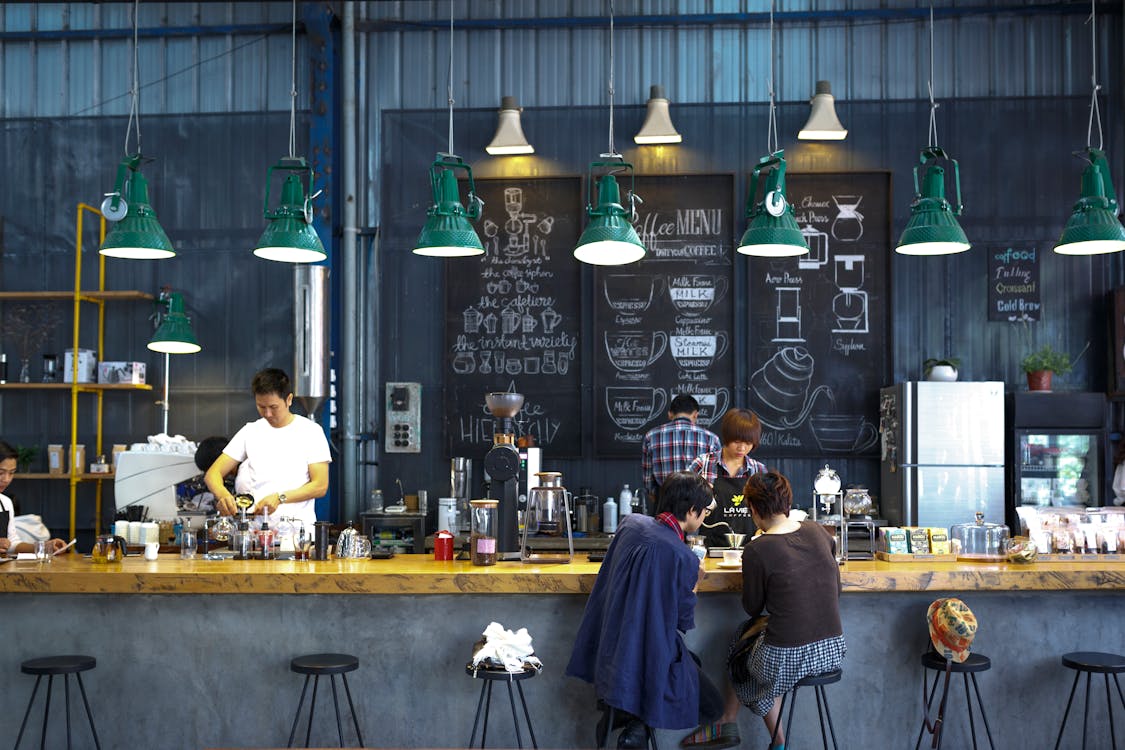 workers behind the counter at a small coffee roasting business